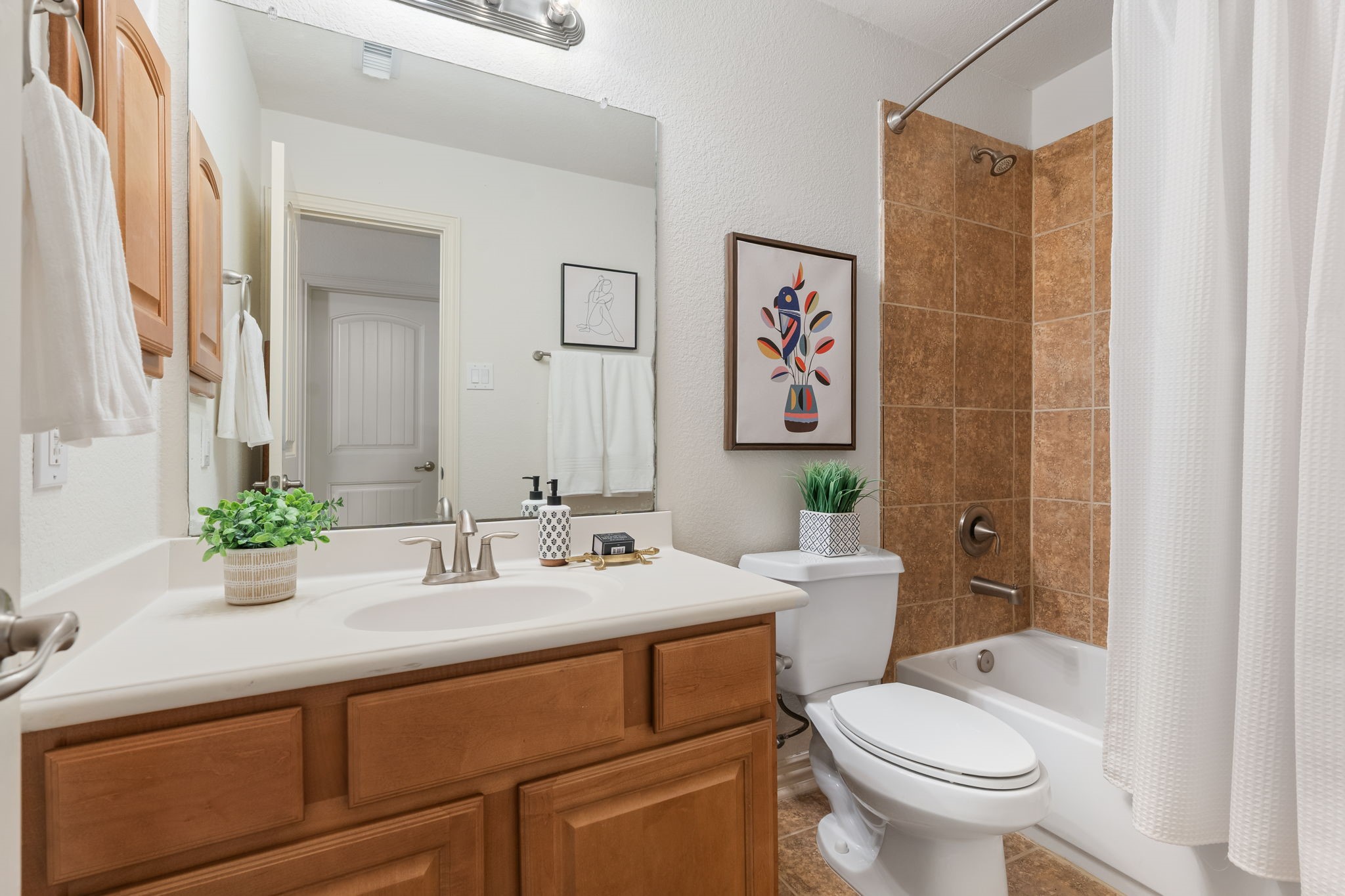 307 Arbor Ridge Lane Conroe, TX 77384 - Photo 29 of 50 a bathroom with a sink a toilet and shower curtain