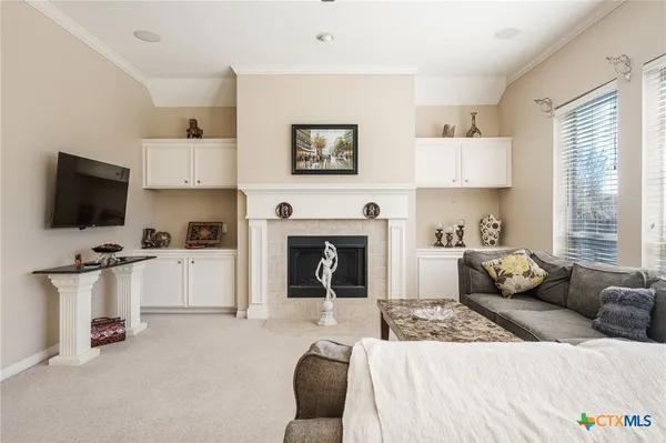 a living room with furniture a fireplace and a flat screen tv