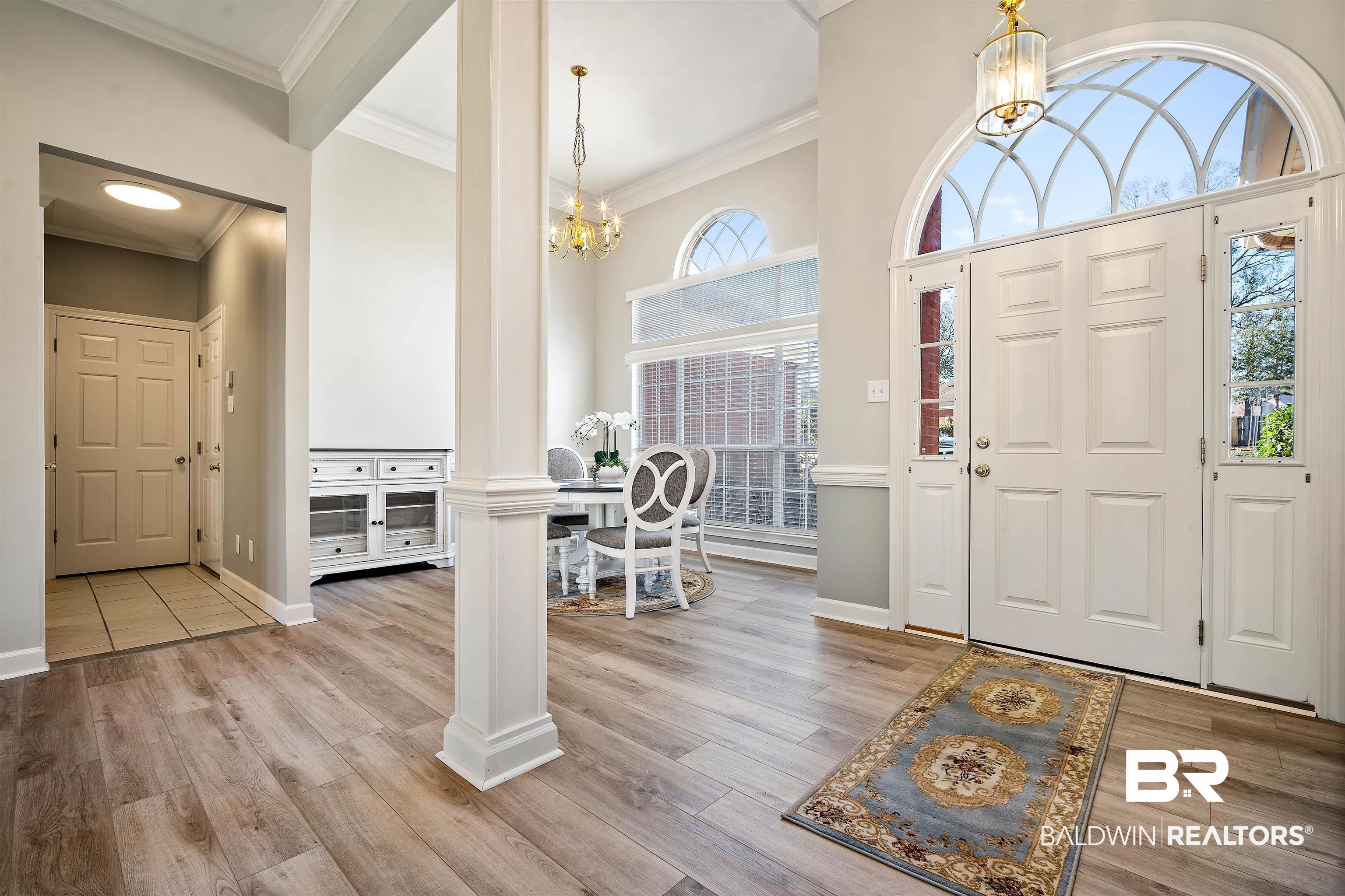 615 Summerlake Place Mobile, AL 36608 - Photo 13 of 35 Entryway with a chandelier, ornamental molding, light wood-style flooring, and ornate columns