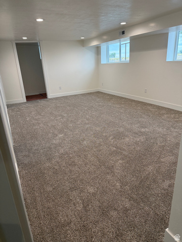 2865 North 3250 W Road Sutherland, UT 84624 - Photo 19 of 28 Spacious room featuring new carpeting, recessed lighting, white walls, and two egress windows