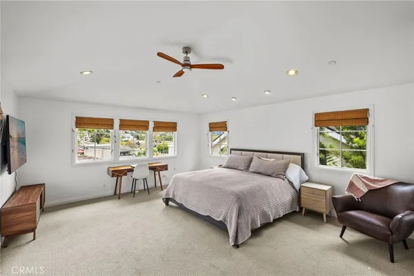 a bedroom with a bed and a couch