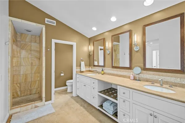 a spacious bathroom with a double vanity sink mirror and double