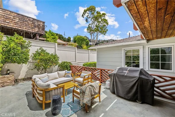 a view of a patio with table and chairs and potted plants
