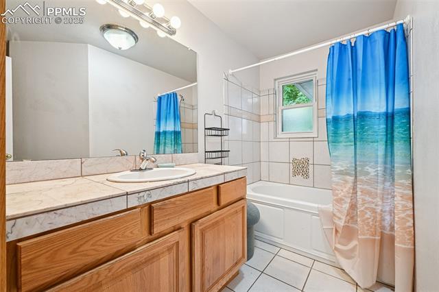 1263 York Road Colorado Springs, CO 80918 - Photo 11 of 29 Full bathroom with shower / tub combo, vanity, and light tile patterned floors