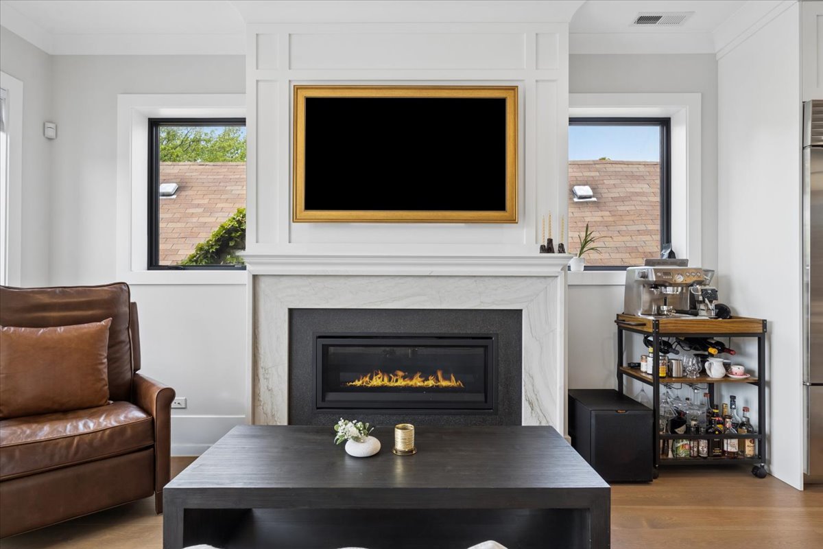3929 North Greenview Avenue, Unit 3 Chicago, IL 60613 - Photo 11 of 35 a living room with a fireplace a flat screen tv and a fireplace