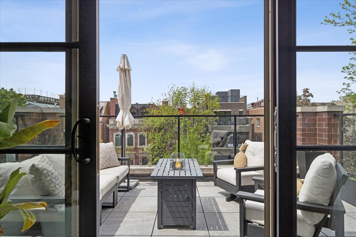 3929 North Greenview Avenue, Unit 3 Chicago, IL 60613 - Photo 12 of 35 a balcony with furniture and a floor to ceiling window