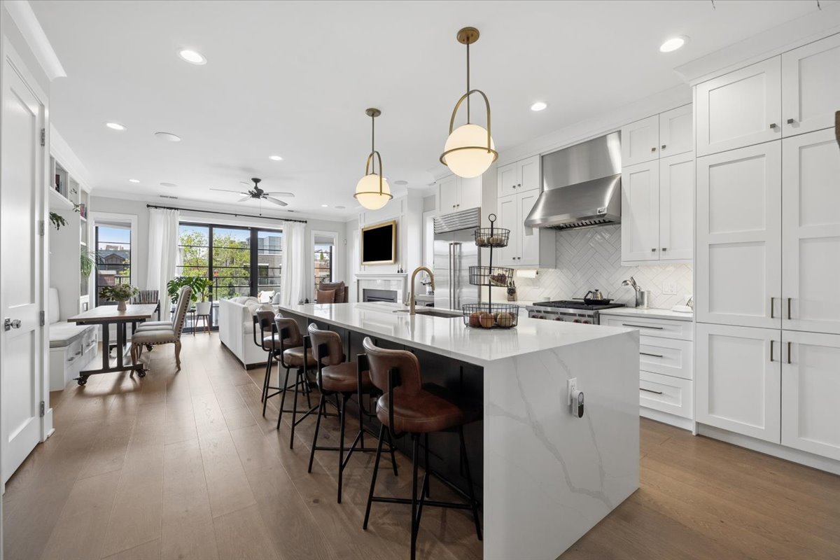 3929 North Greenview Avenue, Unit 3 Chicago, IL 60613 - Photo 2 of 35 a open kitchen with kitchen island granite countertop wooden cabinets and white appliances
