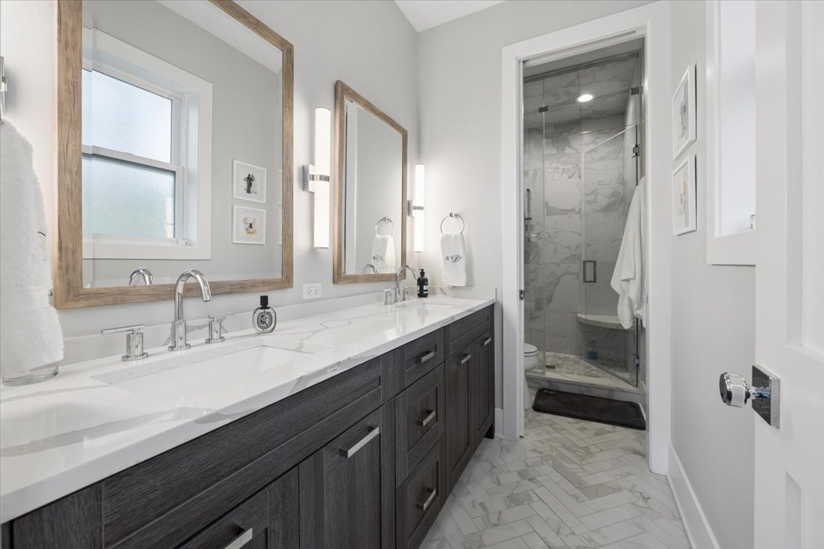 3929 North Greenview Avenue, Unit 3 Chicago, IL 60613 - Photo 24 of 35 a en suite bathroom with a granite countertop sink and a mirror
