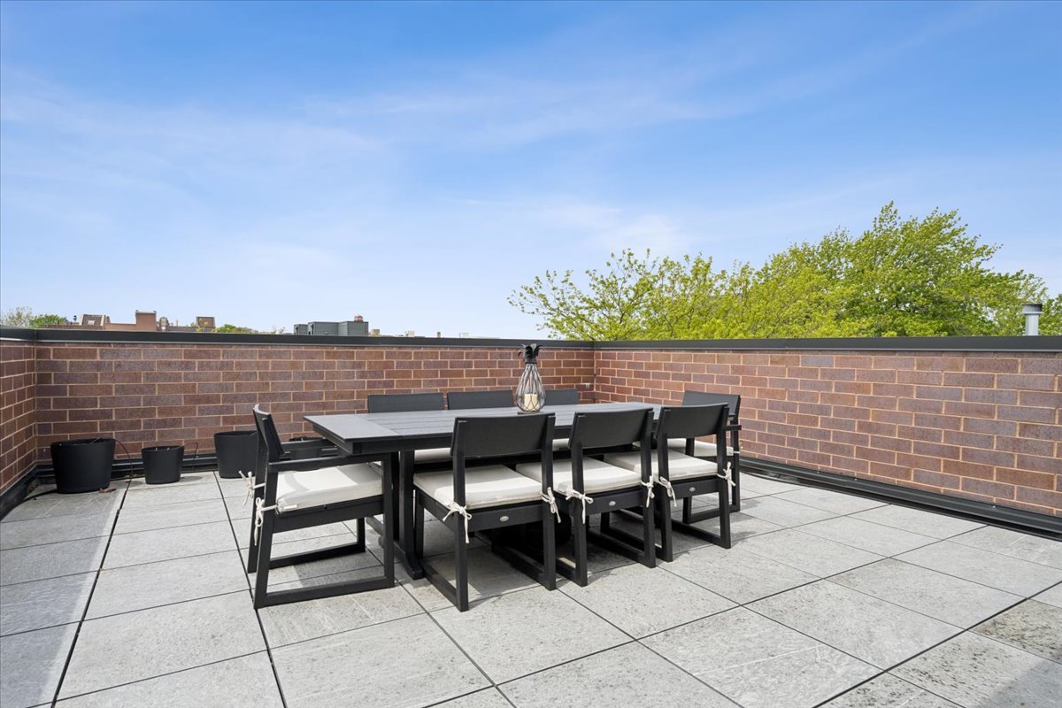 3929 North Greenview Avenue, Unit 3 Chicago, IL 60613 - Photo 30 of 35 a patio with table and chairs