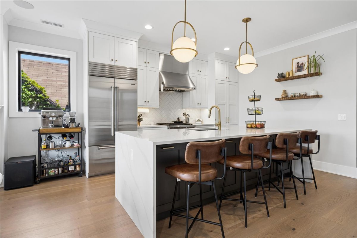 3929 North Greenview Avenue, Unit 3 Chicago, IL 60613 - Photo 5 of 35 a kitchen with stainless steel appliances granite countertop a stove a sink dishwasher a dining table and chairs with wooden floor