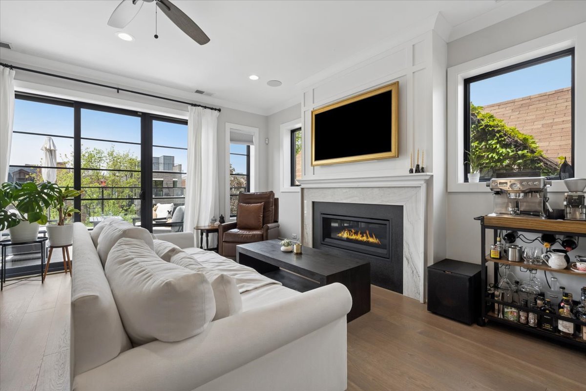 3929 North Greenview Avenue, Unit 3 Chicago, IL 60613 - Photo 8 of 35 a living room with furniture a flat screen tv and a fireplace
