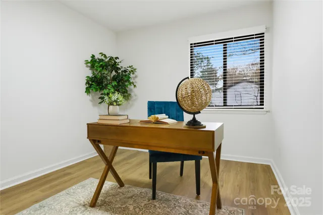 a view of a room that has a table and a potted plant