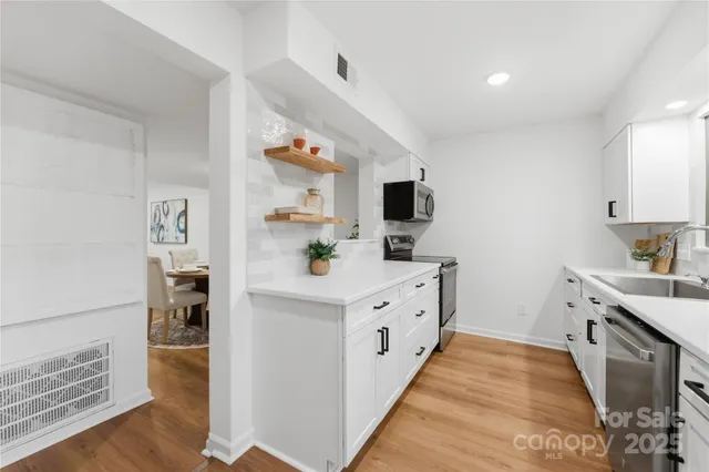 a kitchen with cabinets a sink and appliances