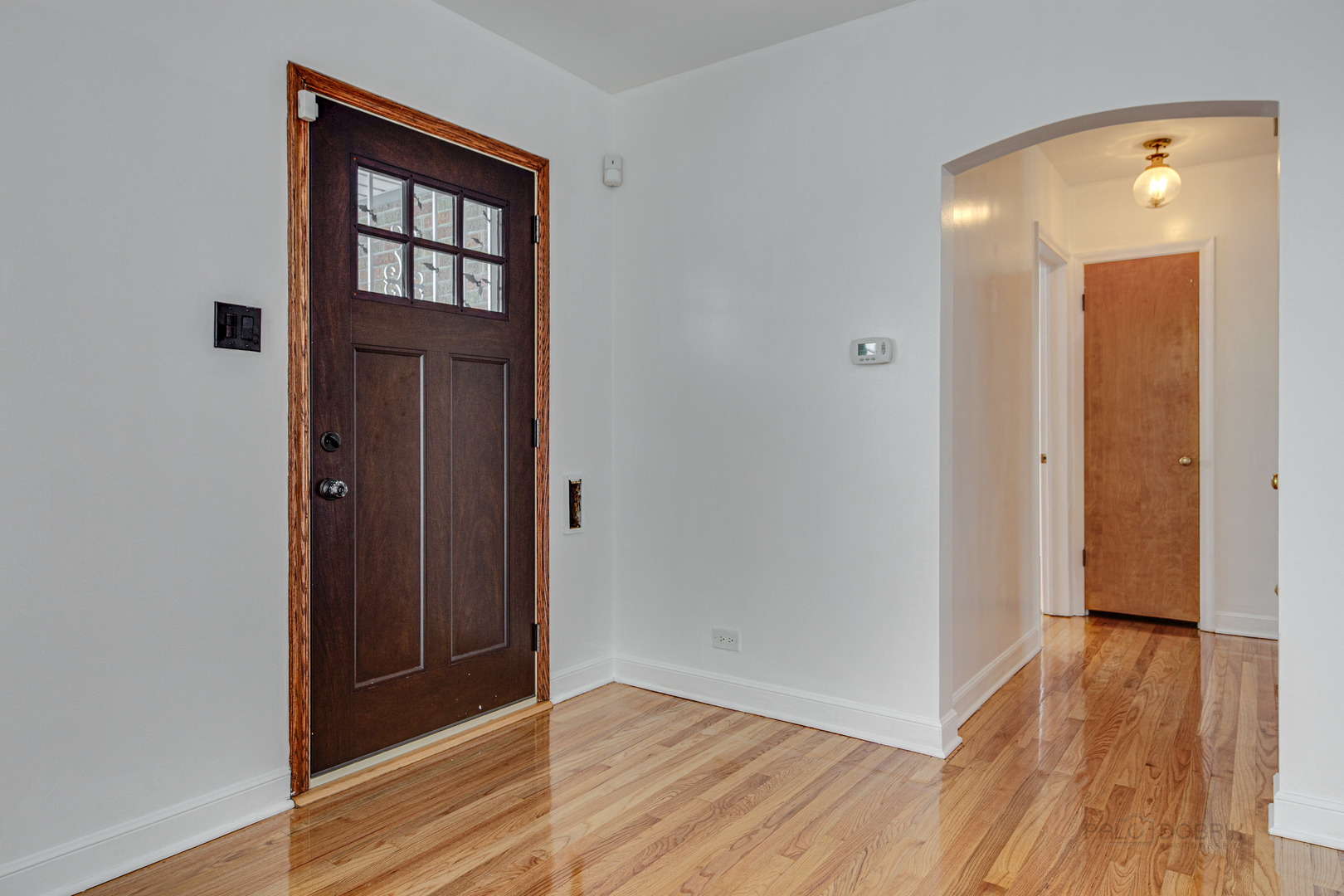 534 Longcommon Road Riverside, IL 60546 - Photo 3 of 30 an empty room with wooden floor and a window