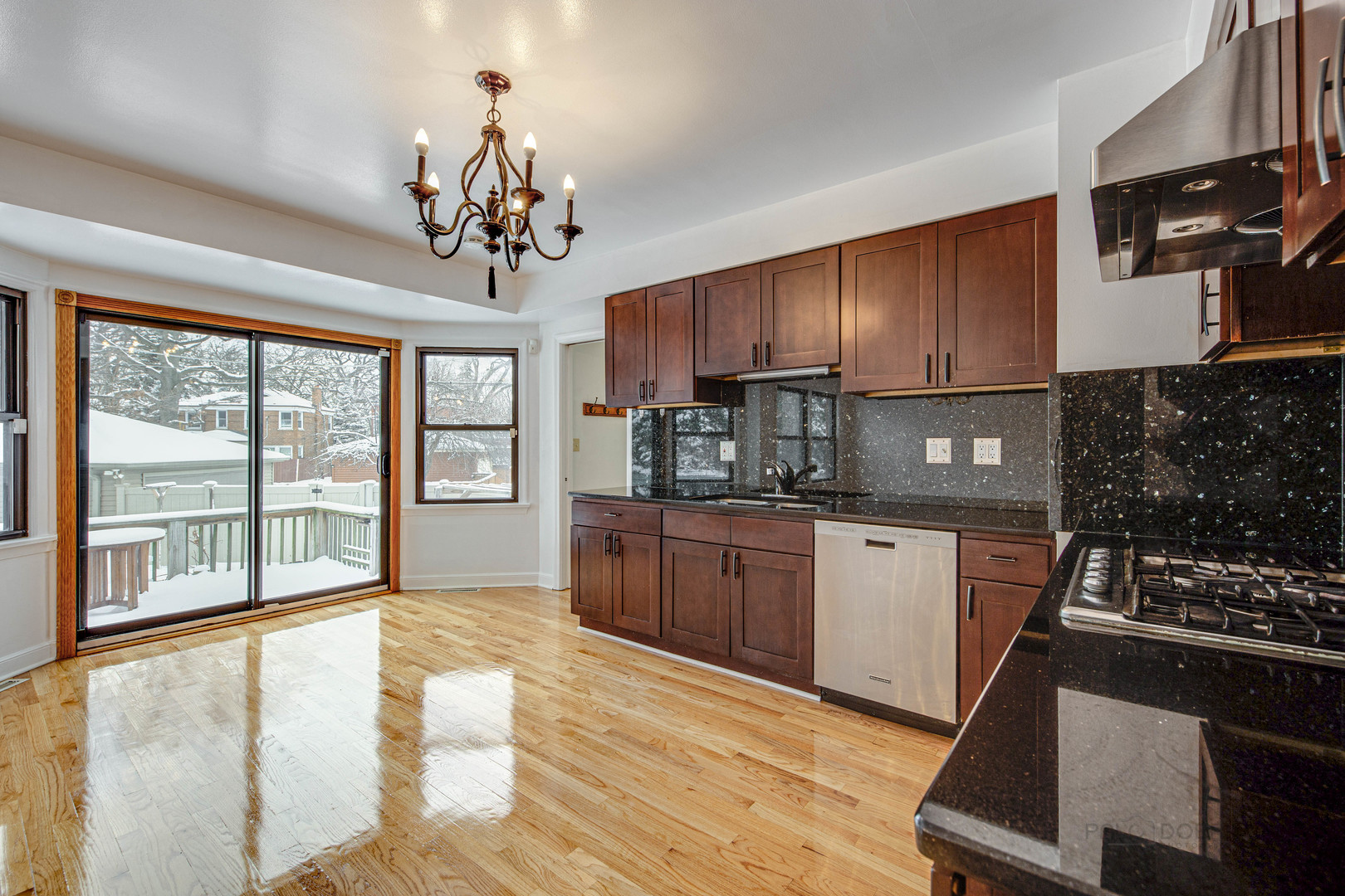 534 Longcommon Road Riverside, IL 60546 - Photo 8 of 30 a kitchen with stainless steel appliances granite countertop a stove a sink dishwasher a microwave oven with cabinets and wooden floor
