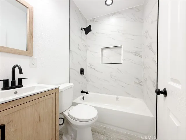a bathroom with a sink toilet and bathtub
