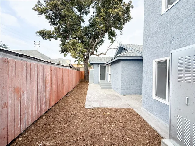a view of a house with a wooden fence