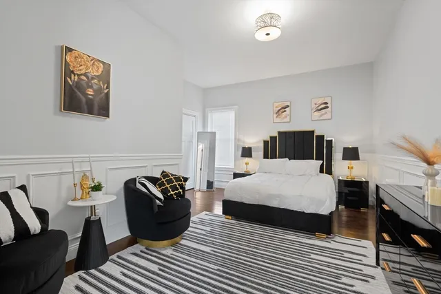 a bedroom with a bed a couch and dresser