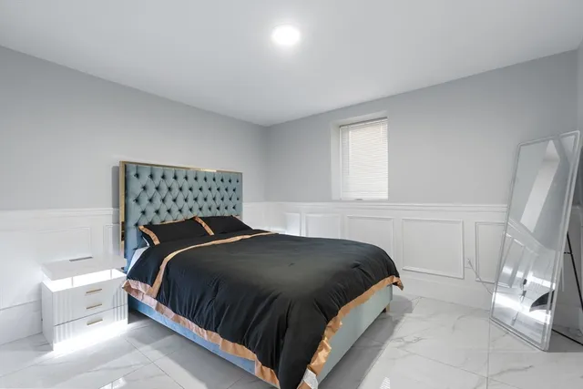 a bedroom with a bed and window