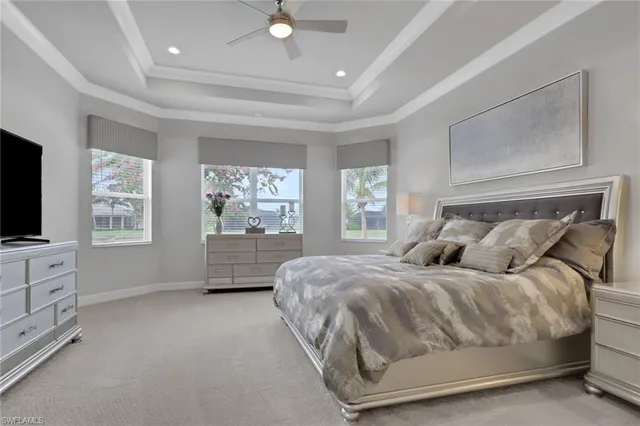 a bedroom with a bed and a flat tv screen on dresser