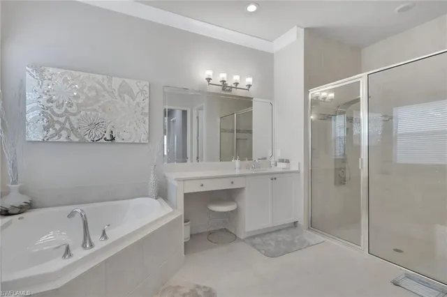 a bathroom with a tub a sink and mirrors