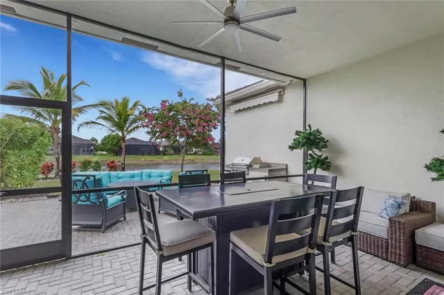 a dining room with furniture potted plants and wooden floor