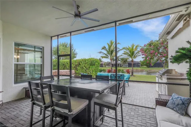 a dining room with furniture and a floor to ceiling window