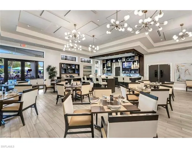 a living room with lots of furniture and a chandelier