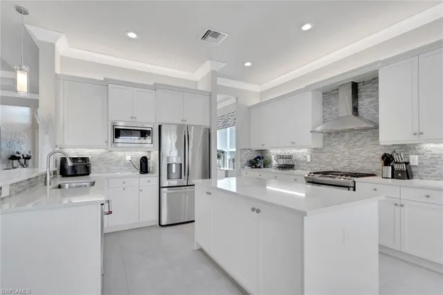 a kitchen with white cabinets and white appliances