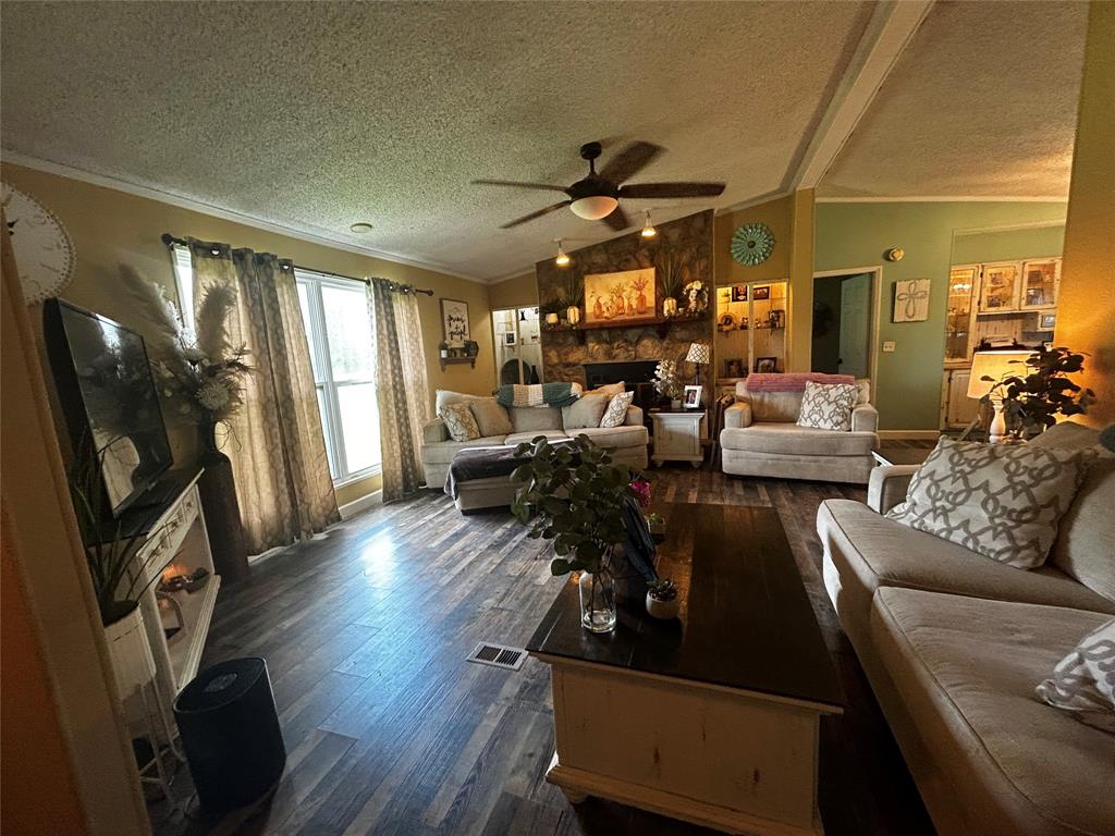 175 Bozman Road Stonewall, LA 71078 - Photo 3 of 8 a living room with furniture and a flat screen tv