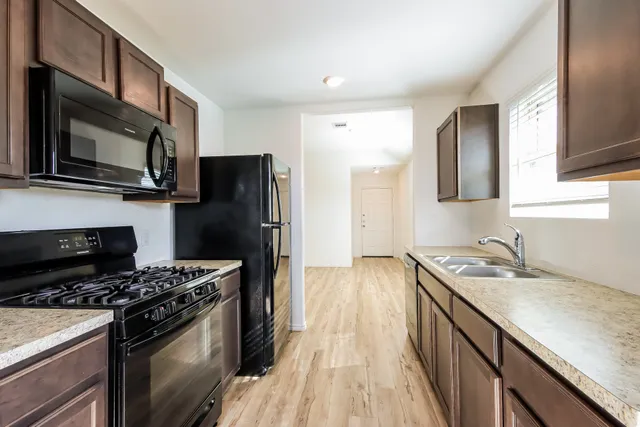 a kitchen with a sink stove and refrigerator