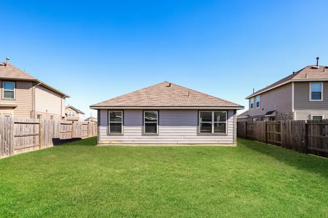 a view of a house with a yard and sitting area