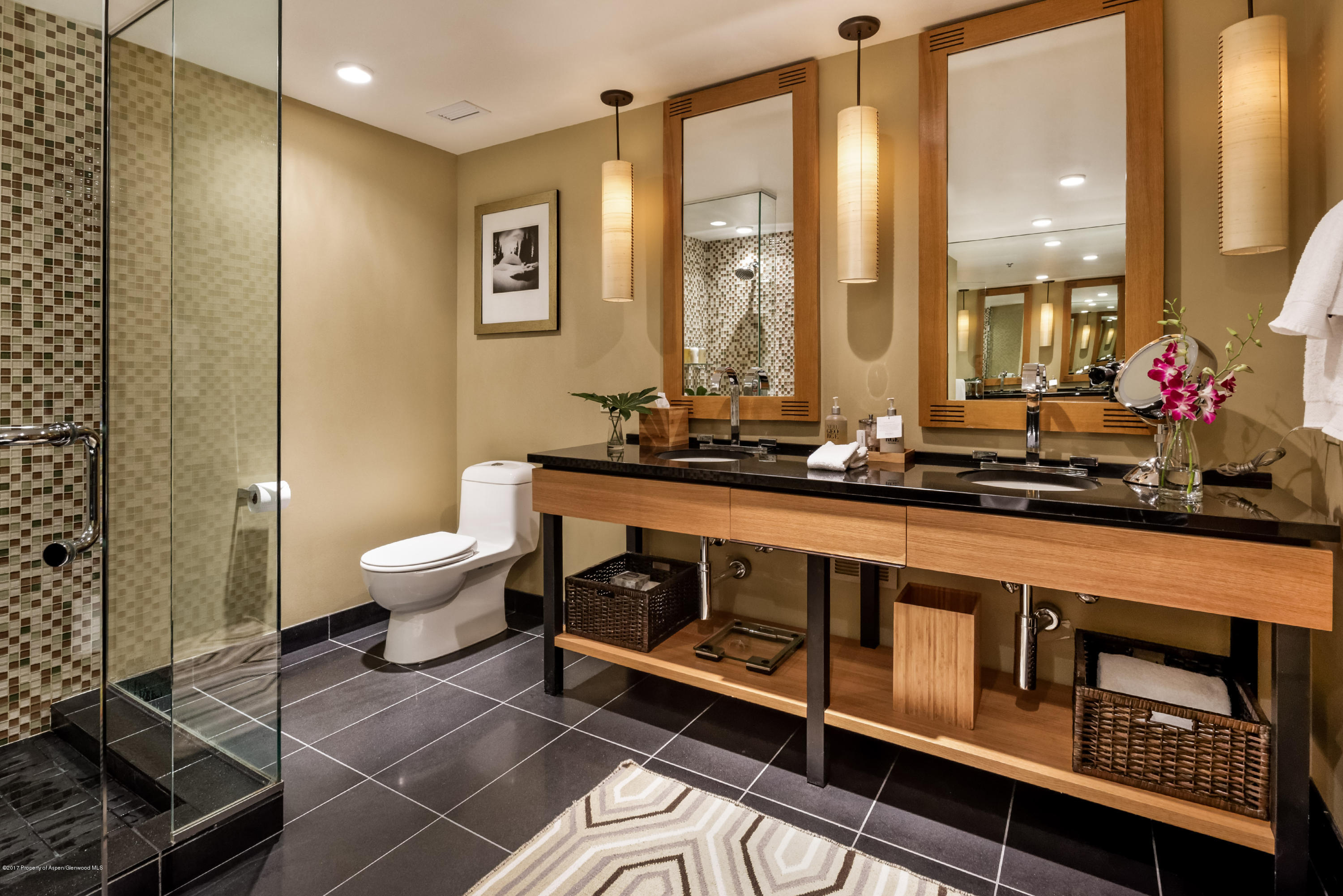 130 Wood Road, Unit 614 Snowmass Village, CO 81615 - Photo 7 of 11 a bathroom with a double vanity sink a toilet and a mirror