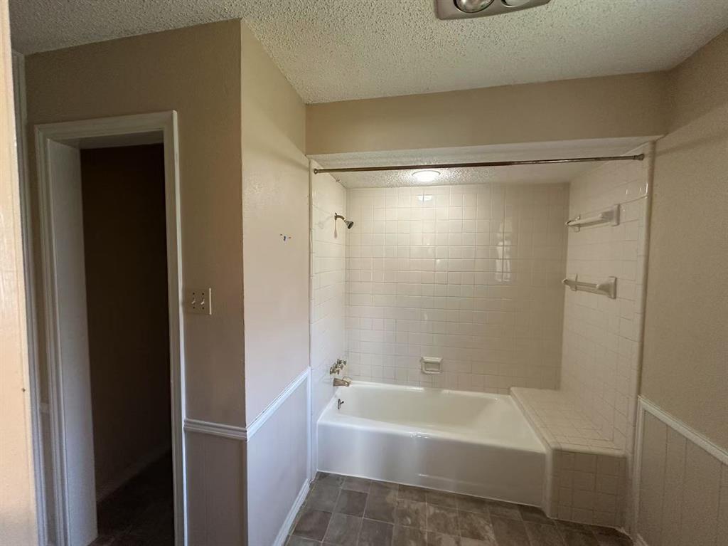 4726 Berridge Lane Dallas, TX 75227 - Photo 11 of 12 a bathroom with a bathtub and a shower