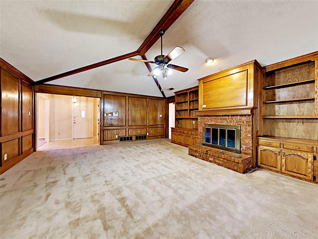 4726 Berridge Lane Dallas, TX 75227 - Photo 3 of 12 a view of a livingroom with an empty space and a fireplace