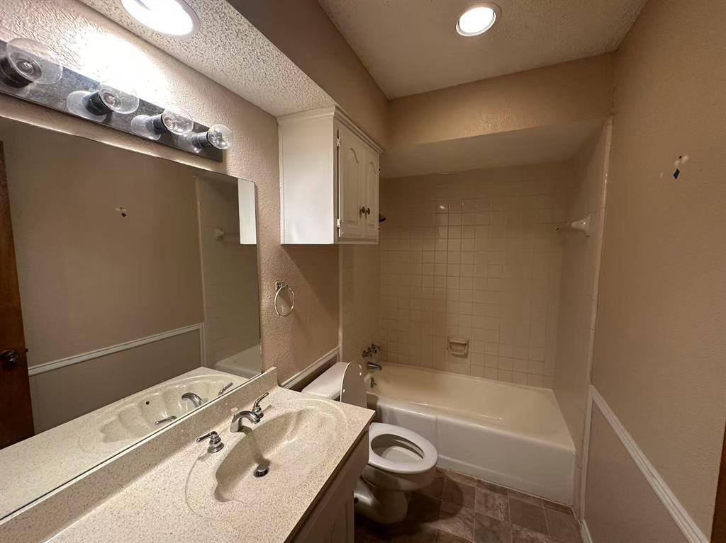 4726 Berridge Lane Dallas, TX 75227 - Photo 9 of 12 a bathroom with a sink toilet and shower