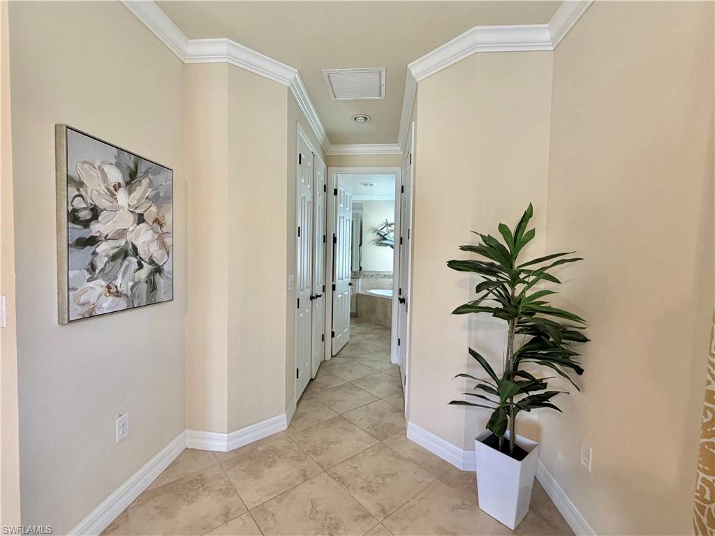 2930 Aviamar Circle Naples, FL 34114 - Photo 17 of 39 a view of a hallway with paintings on the wall