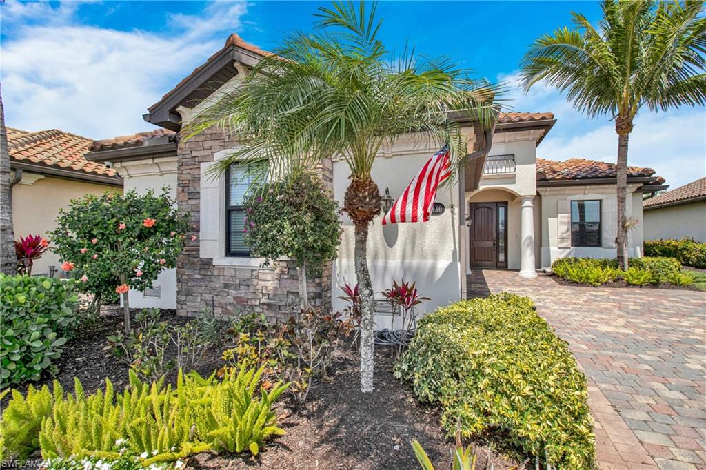 2930 Aviamar Circle Naples, FL 34114 - Photo 2 of 39 front view of a house with a garden