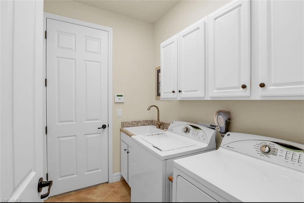 2930 Aviamar Circle Naples, FL 34114 - Photo 25 of 39 a utility room with dryer and washer