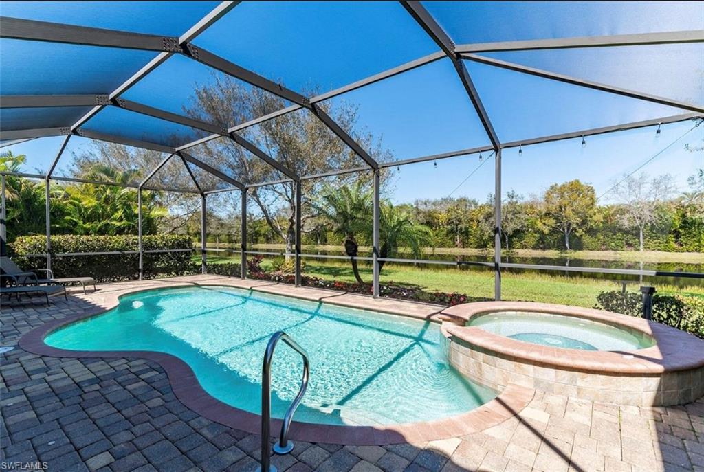 2930 Aviamar Circle Naples, FL 34114 - Photo 26 of 39 a view of a swimming pool with a patio