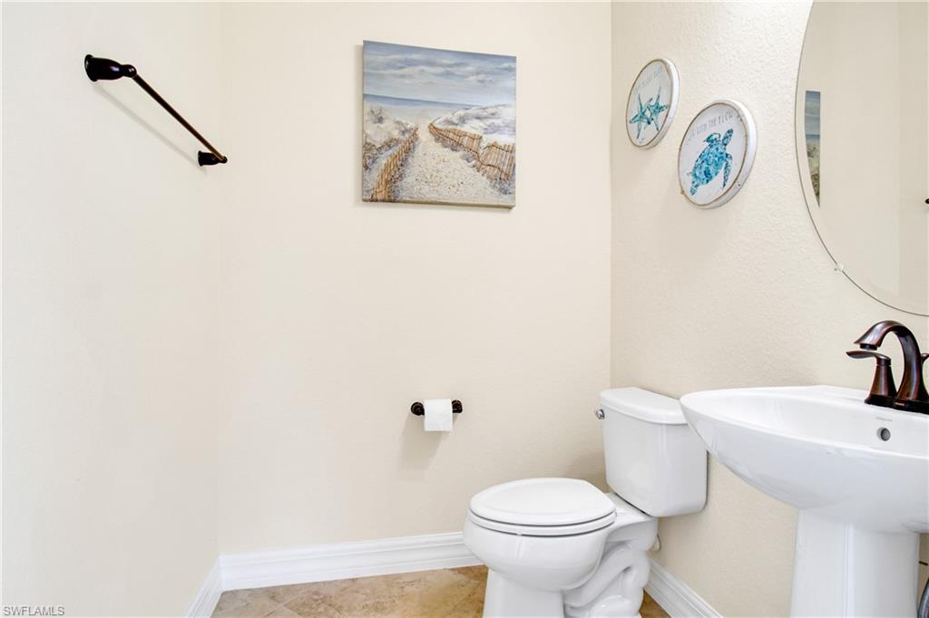 2930 Aviamar Circle Naples, FL 34114 - Photo 32 of 39 a white toilet sitting next to a bathroom sink
