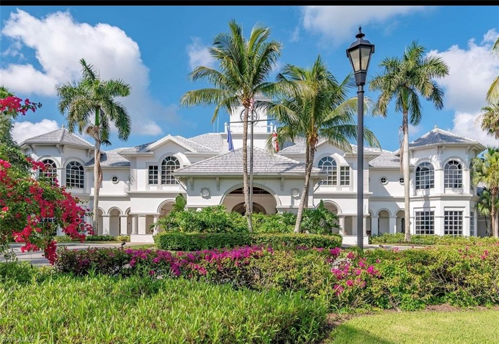 2930 Aviamar Circle Naples, FL 34114 - Photo 36 of 39 a view of a white house with a yard and potted plants