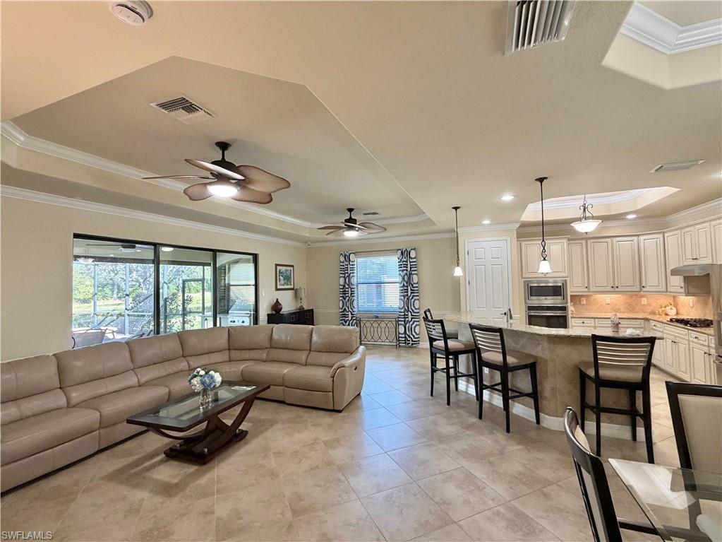 2930 Aviamar Circle Naples, FL 34114 - Photo 9 of 39 a living room with furniture kitchen view and a large window