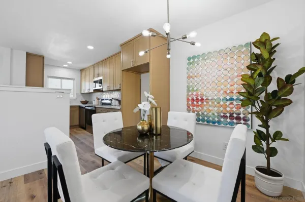 a dining room with furniture and potted plants