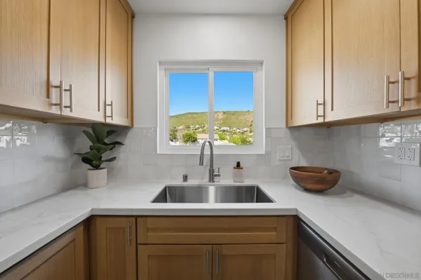 a kitchen with stainless steel appliances granite countertop a sink a stove and a granite counter tops