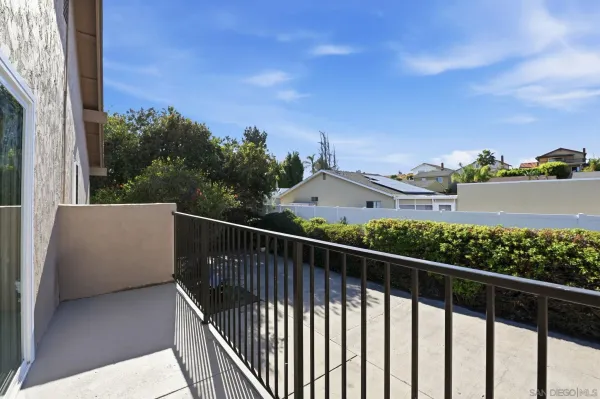 a view of a balcony with wooden fence