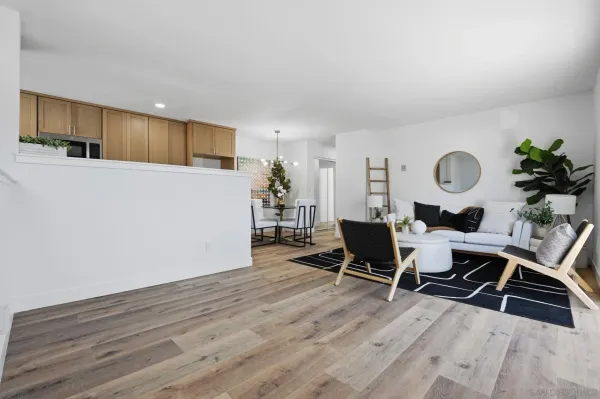a living room with furniture and wooden floor