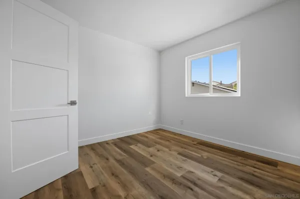 a view of room with window and hardwood floor