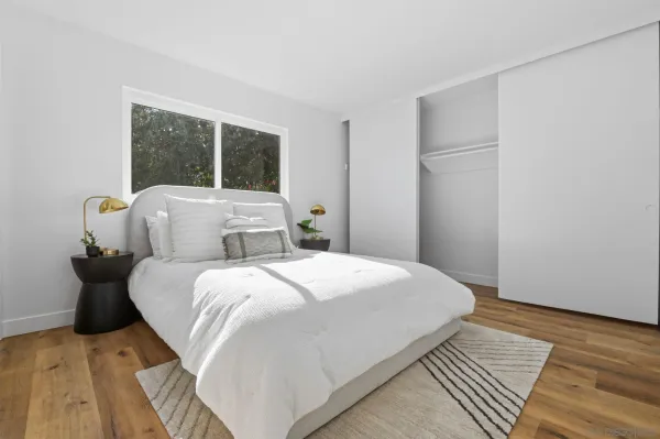 a bedroom with a bed and a window