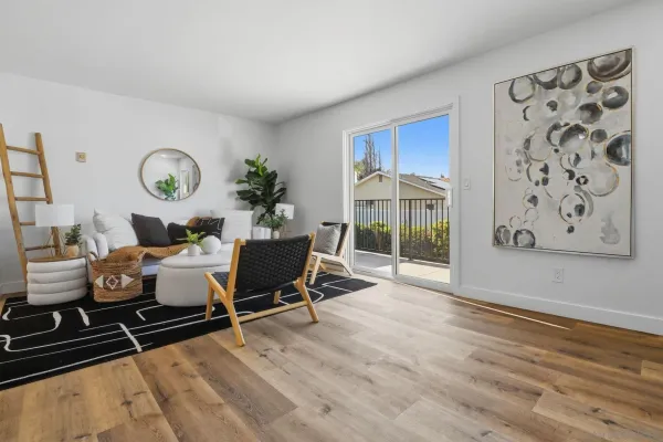 a living room with furniture and wooden floor